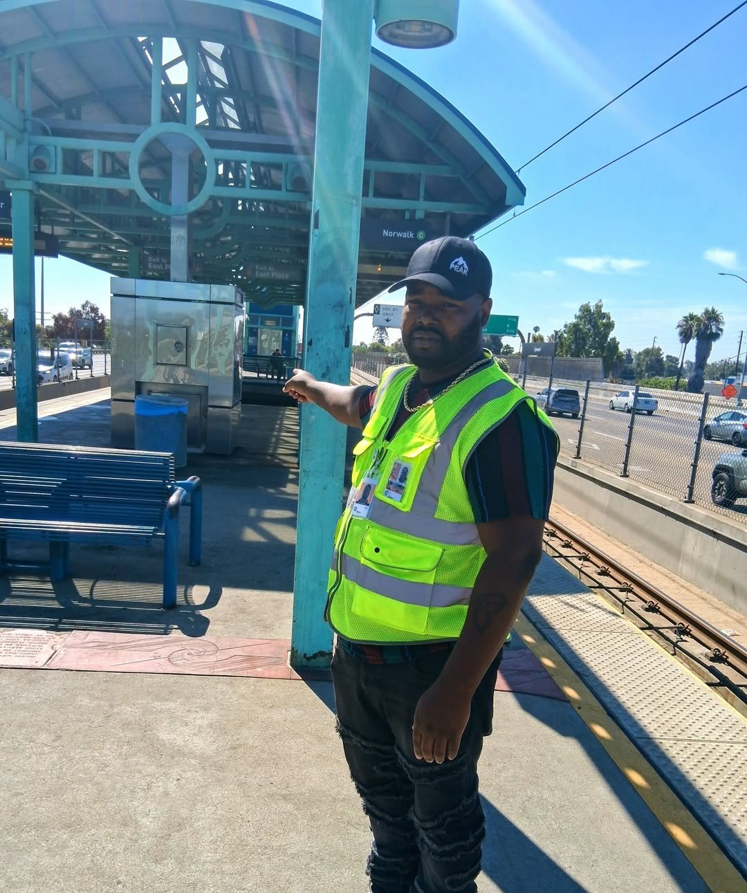 STV Community Intervention Specialist in high-visibility vest at a Metro rail station in Los Angeles